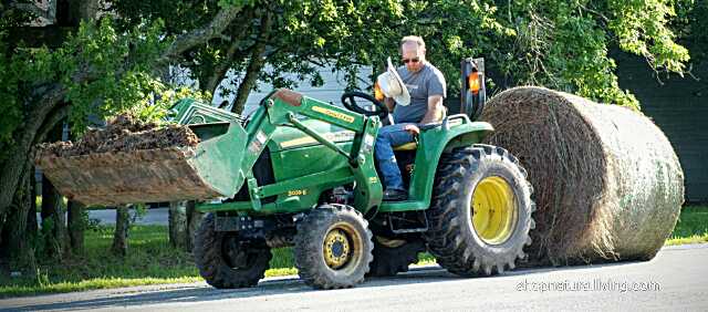 Picture of local farmer riding farm tractor